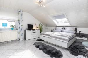 a bedroom with a bed and a skylight at Ferienwohnung Hoffmann in Netphen