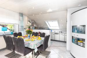 a kitchen and dining room with a table and chairs at Ferienwohnung Hoffmann in Netphen