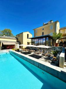 a swimming pool with chairs and umbrellas next to a building at A Villa di Rutali in Rutali