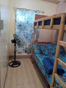 ein Schlafzimmer mit einem Etagenbett mit blauer Decke in der Unterkunft Avong Tako in Baguio City