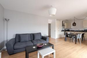 a living room with a couch and a table at GuestReady - London Urban Retreat at East End in London