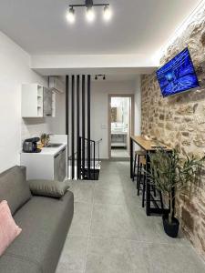 a living room and kitchen with a couch and a table at 1900 Apartments Ioannina in Ioannina