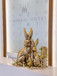 a statue of two rabbits sitting on a shelf at At Herbal Boutique Hotel & Spa in Protaras