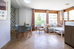 a living room with a couch and a table at Apartamentos Villablino Arturo Soria in Madrid