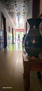 a large green vase sitting on a table in a hallway at Retro Quarter MB in Siem Reap