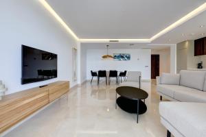 a living room with a couch and a table at Aqua Apartments Vento, Marbella in Marbella