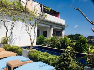 a house with a pool in front of it at Inb Studio Apartemen 32 in Seminyak