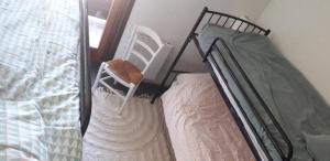 a bed with a dress on it and a chair at Les Isards Pied des pistes in Ax-les-Thermes