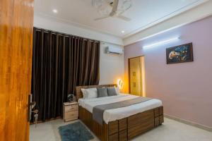 a bedroom with a large bed and a window at Skyport skies netflix prime rooftop in Jaipur