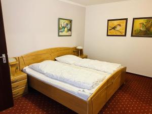 a bed in a room with two pictures on the wall at Baltic Nr. 26 in Scharbeutz
