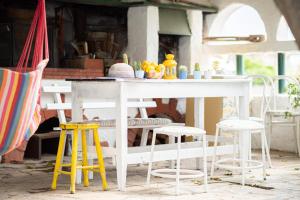 a white table with chairs and a table with fruit on it at Lemon Tree Family House in Vrachati