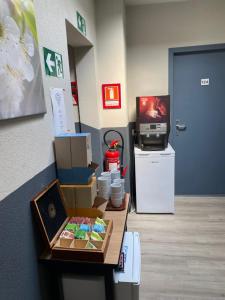 a room with a table with boxes and a tv at Hotel Fauwater in Kasterlee