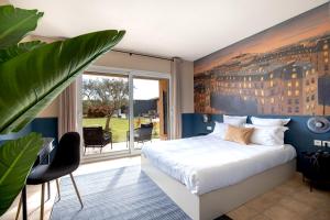 a bedroom with a bed with a painting on the wall at Hôtel La Perna in Pernes-les-Fontaines +48 photos
