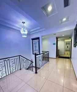 a large room with a staircase and a chandelier at Rainbow Hotel in Alor Setar