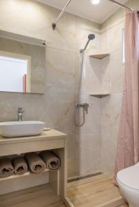 a bathroom with a shower and a sink at Valianos Studios in Alikanas