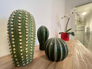 two green vases and a cactus on a table at i giardini di edicart in Bari