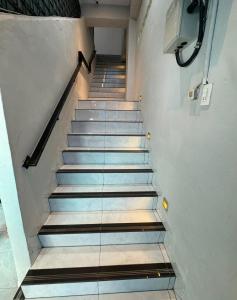 a set of stairs in a building at Horas Hotel in Sibolga