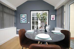 a dining room with a black table and chairs at The Nook by Tŷ SA - Near Bike Park Wales in Nelson