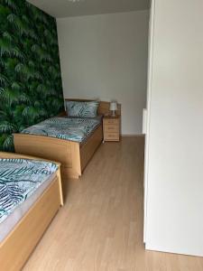 Habitación con 2 camas y pared verde. en Fewo 1, en Gotha
