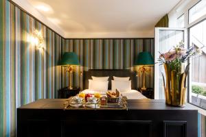 a hotel room with a bed with a tray of food at New Hotel République in Paris