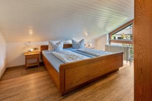 een bed in een kamer met een groot raam bij Kirschenhof in Bad Bellingen