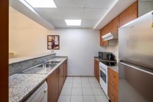 a kitchen with a sink and a refrigerator at Renovated 1 Bed Al Alka 1 In The Greens in Dubai