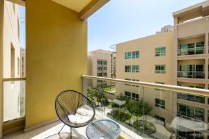 a balcony with two chairs and a building at Renovated 1 Bed Al Alka 1 In The Greens in Dubai