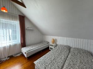 a bedroom with two beds and a window at Two lakes villas&camps in Markutiškės