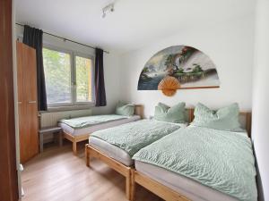 a bedroom with two beds and a window at City rooms in Kapfenberg