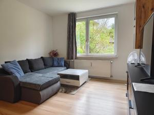 a living room with a couch and a window at City rooms in Kapfenberg