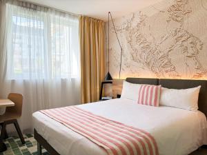 Voodi või voodid majutusasutuse Nonanteneuf Appart-hôtel - Sierre toas