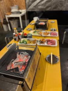 a yellow table with food on it with a grill at Makino Kogen 123 Building / Vacation STAY 79154 in Kaizu