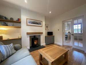 a living room with a couch and a fireplace at Fell View in Portinscale