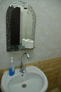 a bathroom with a sink and a mirror at Brother Hotel Dahab in Dahab