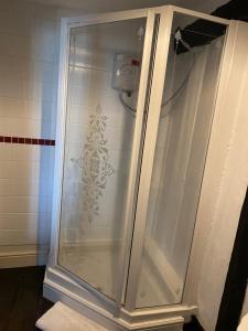 a shower with a glass door in a bathroom at The Kentford in Kentford