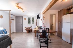 a kitchen and living room with a table and chairs at Bonzoe #5 in Parikia
