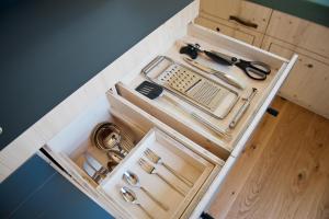 a wooden drawer with scissors and other tools in it at Sleep Space 4 - Salemer See in Salem
