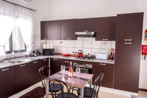 a kitchen with a table and chairs in a kitchen at Villa Sunview in Rabat