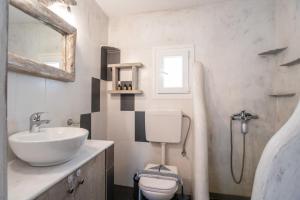 a bathroom with a sink and a toilet and a mirror at Bonzoe #5 in Parikia +51 photos