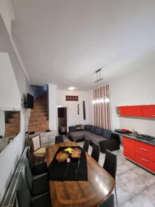 a living room with a table and a couch at Sarok Villa in Siófok