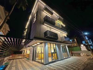 a building at night with lights on it at Hotel Baga Bliss By Celestiial Hospitality, Baga North Goa in Goa