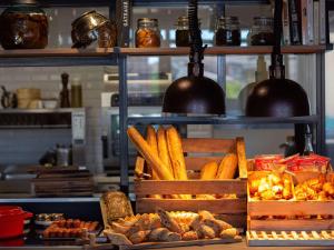 a display of bread and pastries on a shelf at Novotel Bordeaux Centre Ville in Bordeaux