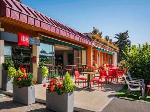 a restaurant with tables and chairs in front of it at ibis Colmar Est - Hotel Restaurant en Alsace in Colmar