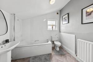 a white bathroom with a sink and a toilet at Stylish Appt in Medway ideal for NHS and contractors, free parking in Gillingham