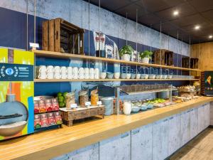 a bakery with a counter with food on it at ibis budget Berlin Kurfürstendamm in Berlin