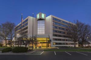 a large building with a clock on top of it at Embassy Suites by Hilton Kansas City Overland Park in Overland Park