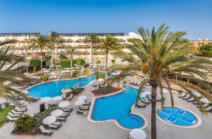 an aerial view of a resort with a pool and palm trees at Barceló Corralejo Bay - Adults Only in Corralejo