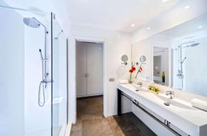 a bathroom with two sinks and a shower at Barceló Corralejo Bay - Adults Only in Corralejo