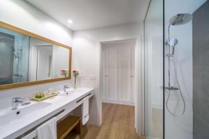a bathroom with a sink and a shower at Barceló Corralejo Bay - Adults Only in Corralejo