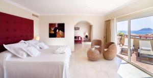 a hotel room with a bed and a view of the ocean at Barceló Corralejo Bay - Adults Only in Corralejo